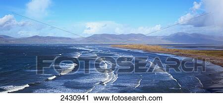 Stock Image - Waves crashing in to the coast along Rosbeigh Beach; County Kerry, Ireland. Fotosearch