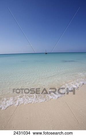 White sand beach and a sailboat in the indian ocean; Vamizi Island, Mozambique View Large Photo Image Picture - White sand beach and a sailboat in the indian ocean; Vamizi Island, Mozambique. Fotosearch