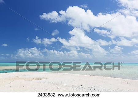 Stock Image - White sand beach and turquoise water on a tropical island; Tikehau, French Polynesia. Fotosearch