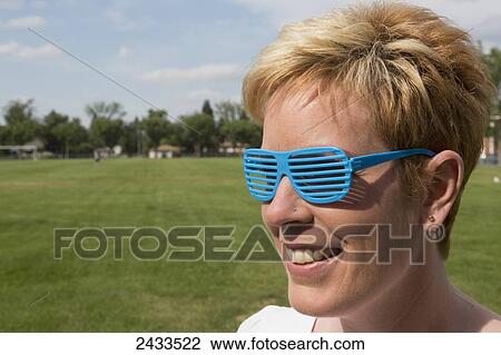 Woman with funny eyeglasses in the park; Edmonton, Alberta, Canada View Large Photo Image Stock Image - Woman with funny eyeglasses in the park; Edmonton, Alberta, Canada. Fotosearch