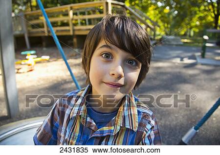 Young boy playing on dish swing at a playground in autumn; Langley, British Columbia, Canada View Large Photo Image Stock Photography - Young boy playing on dish swing at a playground in autumn; Langley, British Columbia, Canada. Fotosearch