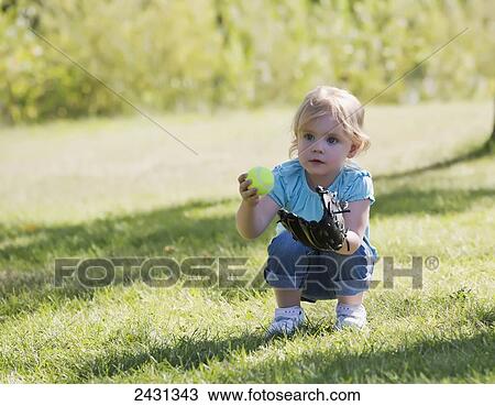Young girl playing with a ball and baseball glove; Edmonton, Alberta, Canada View Large Photo Image Stock Image - Young girl playing with a ball and baseball glove; Edmonton, Alberta, Canada. Fotosearch