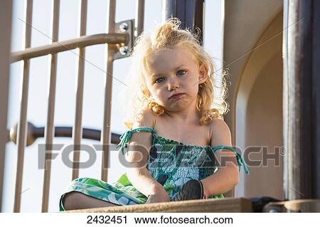 Young girl sitting on a top of a slide in a playground; Spruce Grove, Alberta, Canada View Large Photo Image Stock Image - Young girl sitting on a top of a slide in a playground; Spruce Grove, Alberta, Canada. Fotosearch