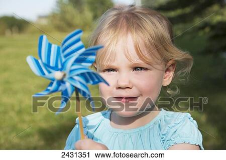 Young girl with pinwheel in a park; Edmonton, Alberta, Canada View Large Photo Image Stock Image - Young girl with pinwheel in a park; Edmonton, Alberta, Canada. Fotosearch