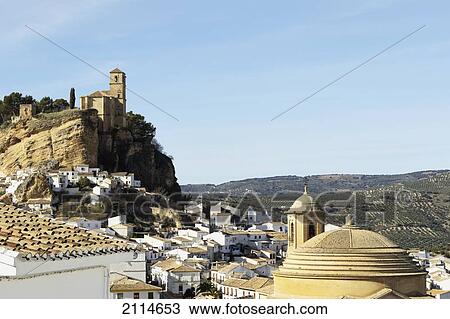 Stock Image - 15Th Century Iglesia De La Villa Built On The Site Of A Nasrid Castle With The 18Th Century Iglesia De La Encarnacion On The Lower Right; Montefrio Granada Spain. Fotosearch