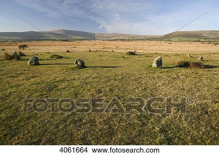 Picture - 16 Blue stones form an egg-shaped ring at Gors Fawr Stone Circle, near village of Mynachlog-ddu, with Preseli mountains in the background; Pemrokeshire, Wales. Fotosearch