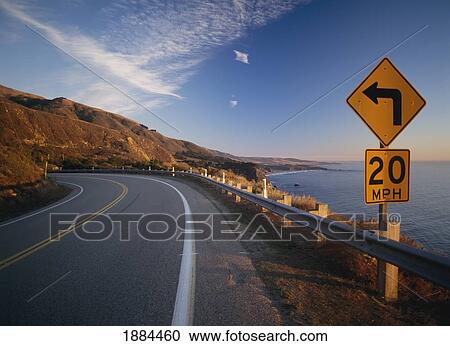 Stock Image - 20Mph Sign On Tight Corner Of Route 1 At Dusk. Fotosearch