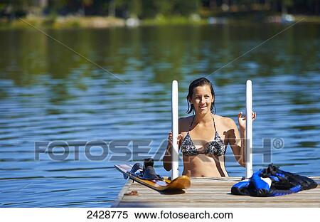 22-year-old girl on dock ladder in water with water ski; Ontario, Canada View Large Photo Image Stock Photography - 22-year-old girl on dock ladder in water with water ski; Ontario, Canada. Fotosearch