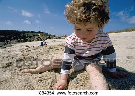 3 Year Old Girl Playing In Sand On Beach In The Scilly Isles View Large Photo Image Picture - 3 Year Old Girl Playing In Sand On Beach In The Scilly Isles. Fotosearch