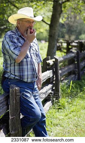 35-Year-Old Man Eating An Apple Outdoors; Langley British Columbia Canada View Large Photo Image Stock Photo - 35-Year-Old Man Eating An Apple Outdoors; Langley British Columbia Canada. Fotosearch