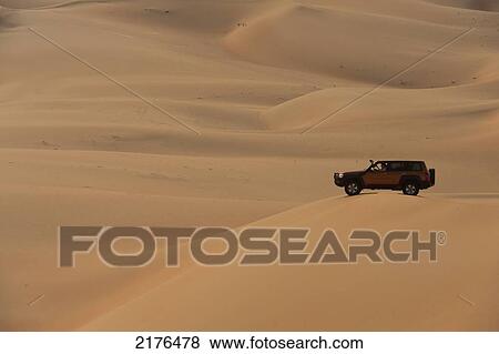 Stock Photo - 4 Wheel Drive Going Across Sand Dunesliwa, Abu Dhabi, Uae. Fotosearch