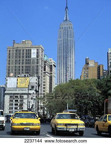 Picture - 5Th Avenue Yellow Cabs & Empire State Building New York Usa. Fotosearch