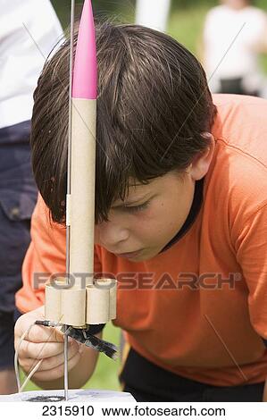 Stock Image - A 10-Year-Old Boy With A Rocket Made In Science Class; Ottawa Ontario Canada. Fotosearch
