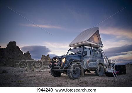 Stock Image - A 1983 Land Rover Defender Camped At Trona Pinacles; Trona California United States Of America. Fotosearch