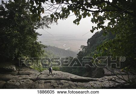 Stock Photography - A Backpacker Trekking Past The View Of Bangladesh From The East Khasi Hills. Fotosearch