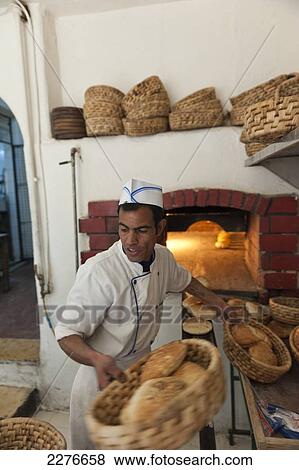 A baker prepares the oven-baked bread for delivery, Al-Saraya Restaurant; Madaba, Jordan View Large Photo Image Stock Photo - A baker prepares the oven-baked bread for delivery, Al-Saraya Restaurant; Madaba, Jordan. Fotosearch