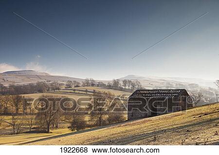 Stock Photo - A Barn On A Hilly Landscape In The Fog; Yorkshire Dales, England. Fotosearch