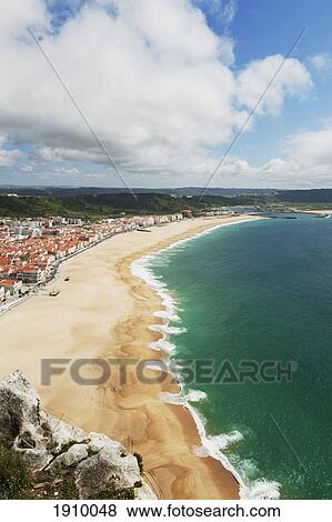 A Beach Along The Bay; Nazare, Portugal View Large Photo Image Stock Photo - A Beach Along The Bay; Nazare, Portugal. Fotosearch