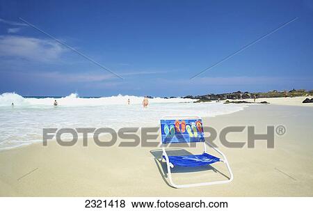 A beach chair on the beach by the water's edge; Hawaii, United States of America View Large Photo Image Stock Photo - A beach chair on the beach by the water's edge; Hawaii, United States of America. Fotosearch