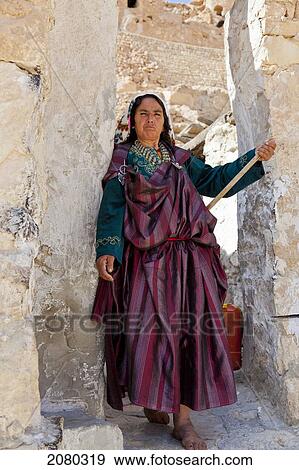 Stock Photo - A Berber Woman Stands In The Doorway In The Largely Abandoned Hilltop Village Of Chenini; Tunisia, North Africa. Fotosearch
