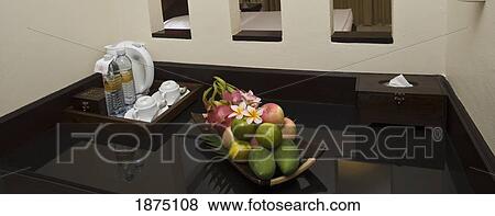 Stock Photo - A Beverage And Fruit Tray Displayed On A Table. Fotosearch