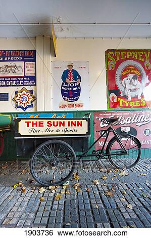 A Bicycle Parked On A Walkway With Colorful Advertisements; Beamish, Durham, England View Large Photo Image Stock Photograph - A Bicycle Parked On A Walkway With Colorful Advertisements; Beamish, Durham, England. Fotosearch