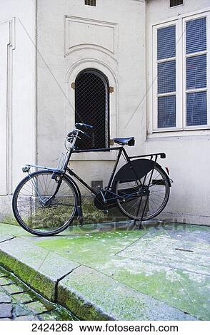 A bicycle parked outside a white building, Marais district; Paris, France View Large Photo Image Stock Photo - A bicycle parked outside a white building, Marais district; Paris, France. Fotosearch