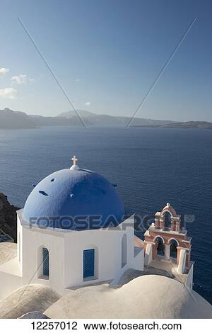 A blue domed church and pink bell tower overlooking the caldera; Oia, Santorini, Cyclades, Greek Islands, Greece View Large Photo Image Stock Image - A blue domed church and pink bell tower overlooking the caldera; Oia, Santorini, Cyclades, Greek Islands, Greece. Fotosearch