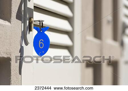 A Blue Key Tag In The Shape Of A Fish With A Number Six; Rimini, Emilia-Romagna, Italy View Large Photo Image Picture - A Blue Key Tag In The Shape Of A Fish With A Number Six; Rimini, Emilia-Romagna, Italy. Fotosearch