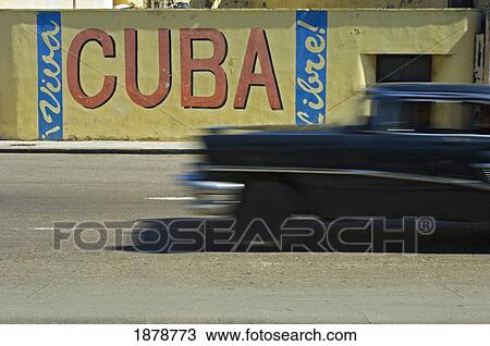 A Blurred Classic Car Passes A Viva Cuba Sign. View Large Photo Image Stock Image - A Blurred Classic Car Passes A Viva Cuba Sign.. Fotosearch