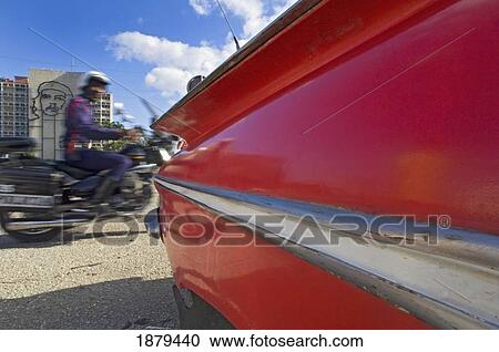 Stock Image - A Blurred Police Motorcyclist Passing The Che Guevara Sculpture In Plaza De La Revoluci? n.. Fotosearch