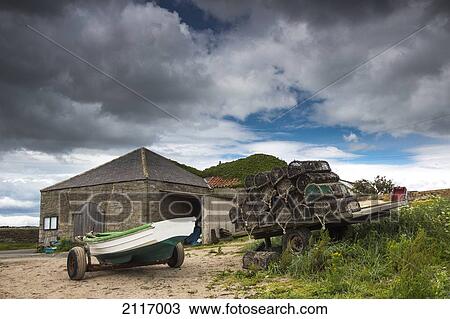 Stock Image - A Boat And Traps In A Trailer On The Beach; Boulmer Northumberland England. Fotosearch