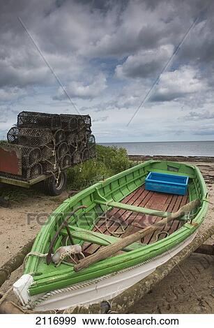 Stock Photo - A Boat And Traps In A Trailer On The Beach; Boulmer Northumberland England. Fotosearch