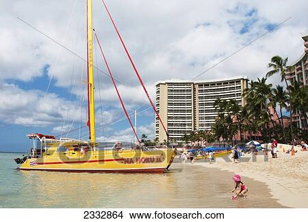Picture - A Boat, Hotel And People On The Beach Along The Shoreline; Waikiki, Oahu, Hawaii, United States Of America. Fotosearch