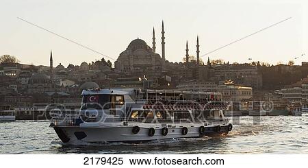 Stock Photography - A Boat In The Bosphorus River With Suleymaniye Mosque In The Background; Istanbul Turkey. Fotosearch