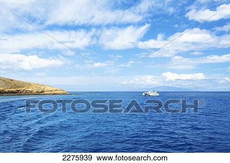 A boat in the pacific ocean off the coast of an hawaiian island; Hawaii, United States of America View Large Photo Image Stock Photo - A boat in the pacific ocean off the coast of an hawaiian island; Hawaii, United States of America. Fotosearch