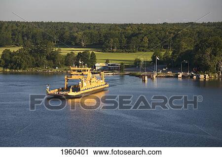 Stock Image - A Boat In The Water At The Entrance Of The Fjord; Stockholm, Sweden. Fotosearch