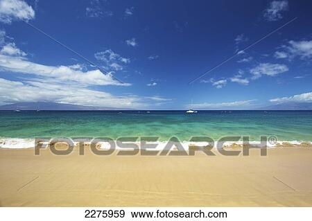 A boat mooring in the water in the distance as viewed from the beach on the coast of an hawaiian island; Hawaii, United States of America View Large Photo Image Stock Photo - A boat mooring in the water in the distance as viewed from the beach on the coast of an hawaiian island; Hawaii, United States of America. Fotosearch