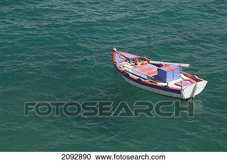 A Boat Mooring In The Water; Mitakas, Island Of Milos, Greece View Large Photo Image Stock Image - A Boat Mooring In The Water; Mitakas, Island Of Milos, Greece. Fotosearch