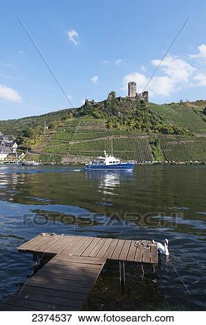 A boat on Moselle river with vineyards on the slopes; Mosel, Germany View Large Photo Image Stock Photo - A boat on Moselle river with vineyards on the slopes; Mosel, Germany. Fotosearch