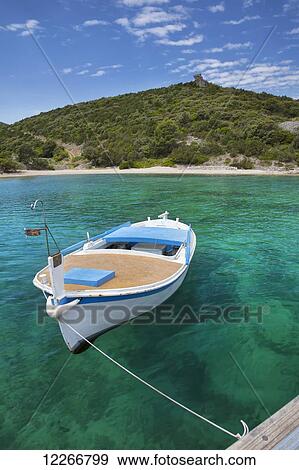 Stock Photo - A boat rests in clear water on the Island of Brac; Povlja, Island of Brac, Croatia. Fotosearch