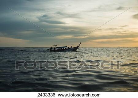 A boat sails across the Andaman Sea towards the island of Koh Phi Phi in southern Thailand; Thailand View Large Photo Image Stock Photograph - A boat sails across the Andaman Sea towards the island of Koh Phi Phi in southern Thailand; Thailand. Fotosearch