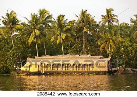 A Boat Sitting At The Shoreline With Palm Trees; Kerela India View Large Photo Image Stock Image - A Boat Sitting At The Shoreline With Palm Trees; Kerela India. Fotosearch