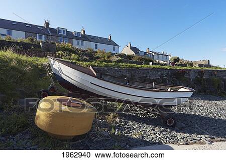 A Boat Sitting On A Trailer On The Rocky Shore; Craster, Northumberland, England View Large Photo Image Stock Image - A Boat Sitting On A Trailer On The Rocky Shore; Craster, Northumberland, England. Fotosearch