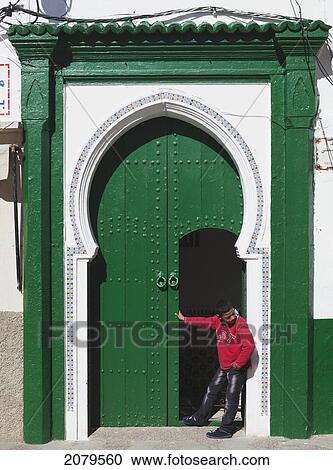 A Boy Stands In An Open Doorway; Asilah Morocco View Large Photo Image Stock Image - A Boy Stands In An Open Doorway; Asilah Morocco. Fotosearch