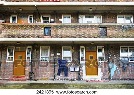 A brick residential building with clothing hanging to dry outside the door; London, England View Large Photo Image Stock Photography - A brick residential building with clothing hanging to dry outside the door; London, England. Fotosearch