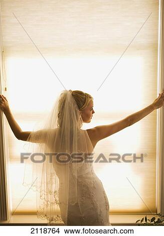 Picture - A Bride Pondering Her Big Day While Looking Out A Window; Pine Grove California Usa. Fotosearch