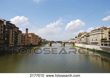 Stock Image - A Bridge Crossing A River; Florence Italy. Fotosearch