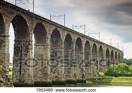 Stock Photo - A Bridge With Arches And Power Lines On Top; Berwick Northumberland England. Fotosearch