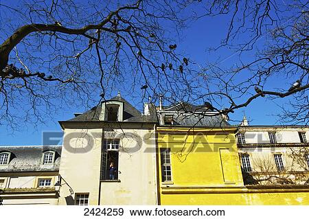 A bright yellow building in the historical district of Marais; Paris, France View Large Photo Image Stock Photo - A bright yellow building in the historical district of Marais; Paris, France. Fotosearch